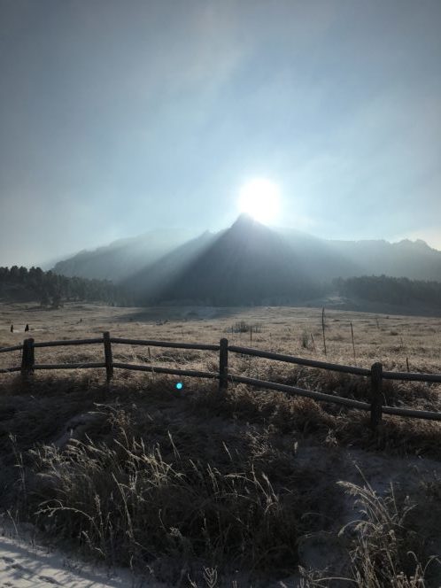 The sun coming out over the flat-iron mountains in Boulder, CO.